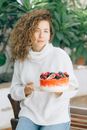 Girl in White Sweater Holding Tray of Fruits