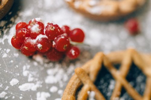 Free Close-up of fresh lingonberries sprinkled with sugar and pastry on a powdered surface, capturing a sweet aesthetic. Stock Photo