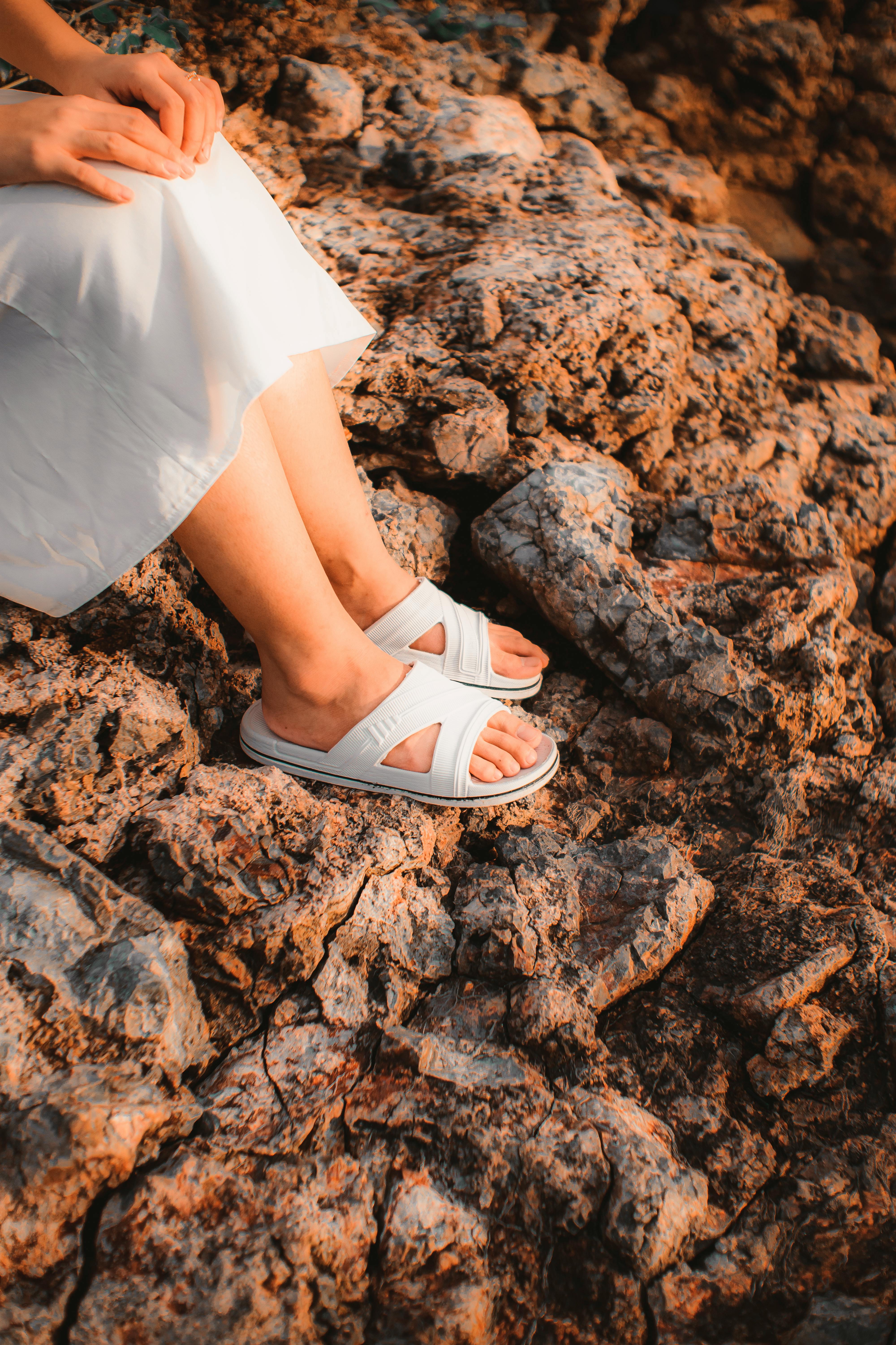 Free Crop woman in stylish outfit resting on rough mount Stock Photo