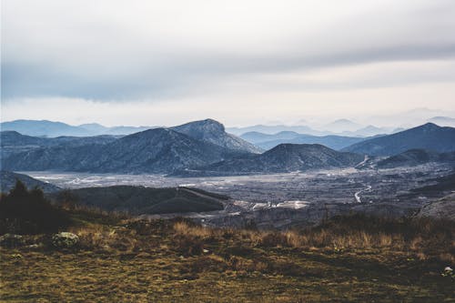 Gray Mountains and Brown and Green Weeds and Grass