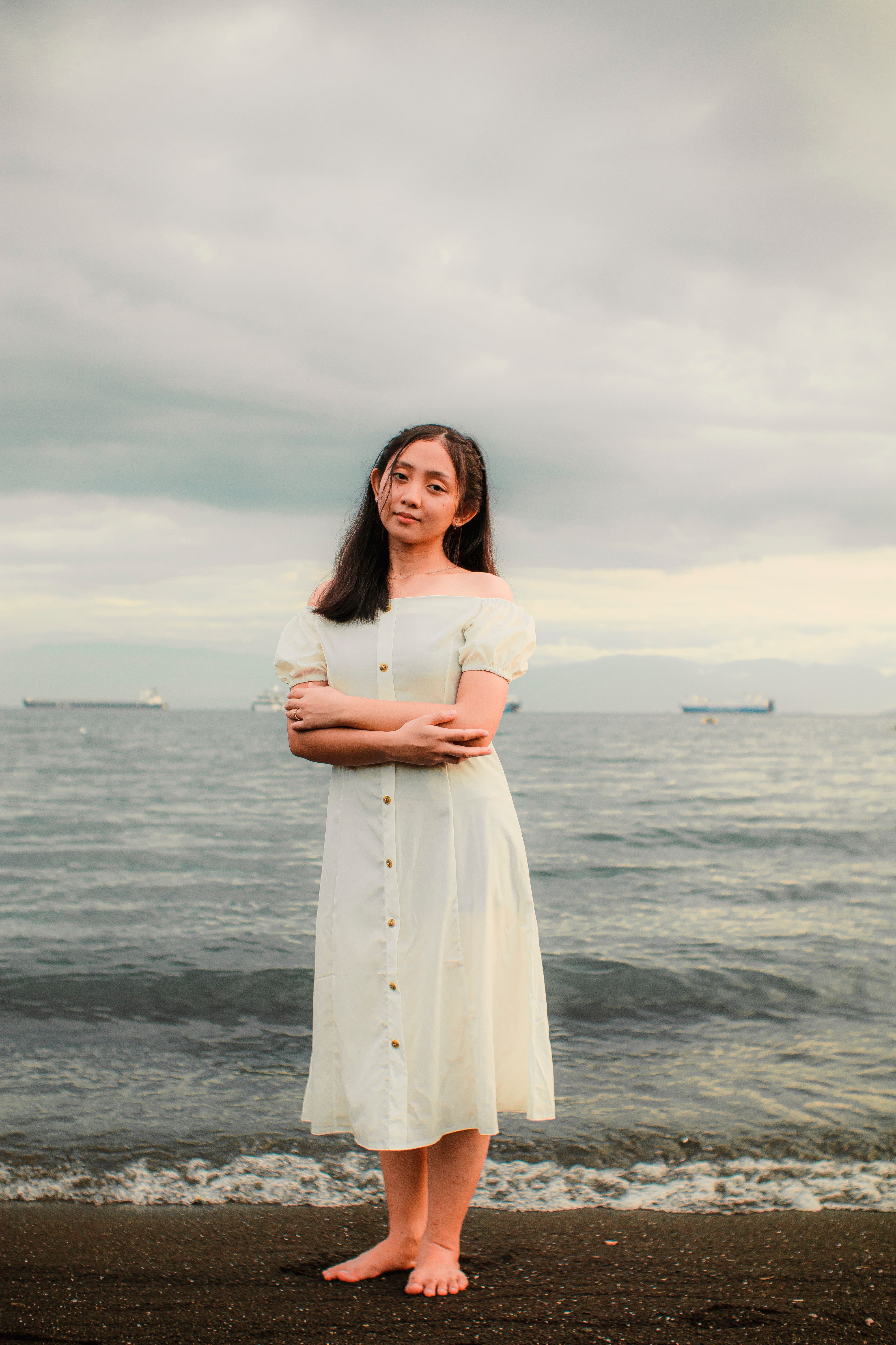 A Woman in White Dress Standing on the Beach · Free Stock Photo