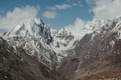 Free A stunning view of snow-capped mountains and a glacier under a clear blue sky. Stock Photo