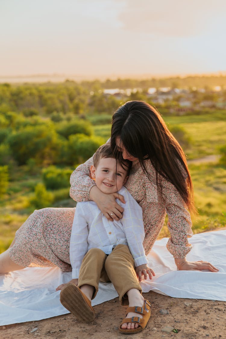 Happy Mother With Little Son In Nature