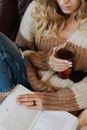 Woman in Brown Sweater Holding Glass Mug