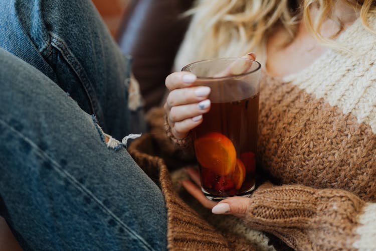 Woman Holding Tall Glass Of Tea