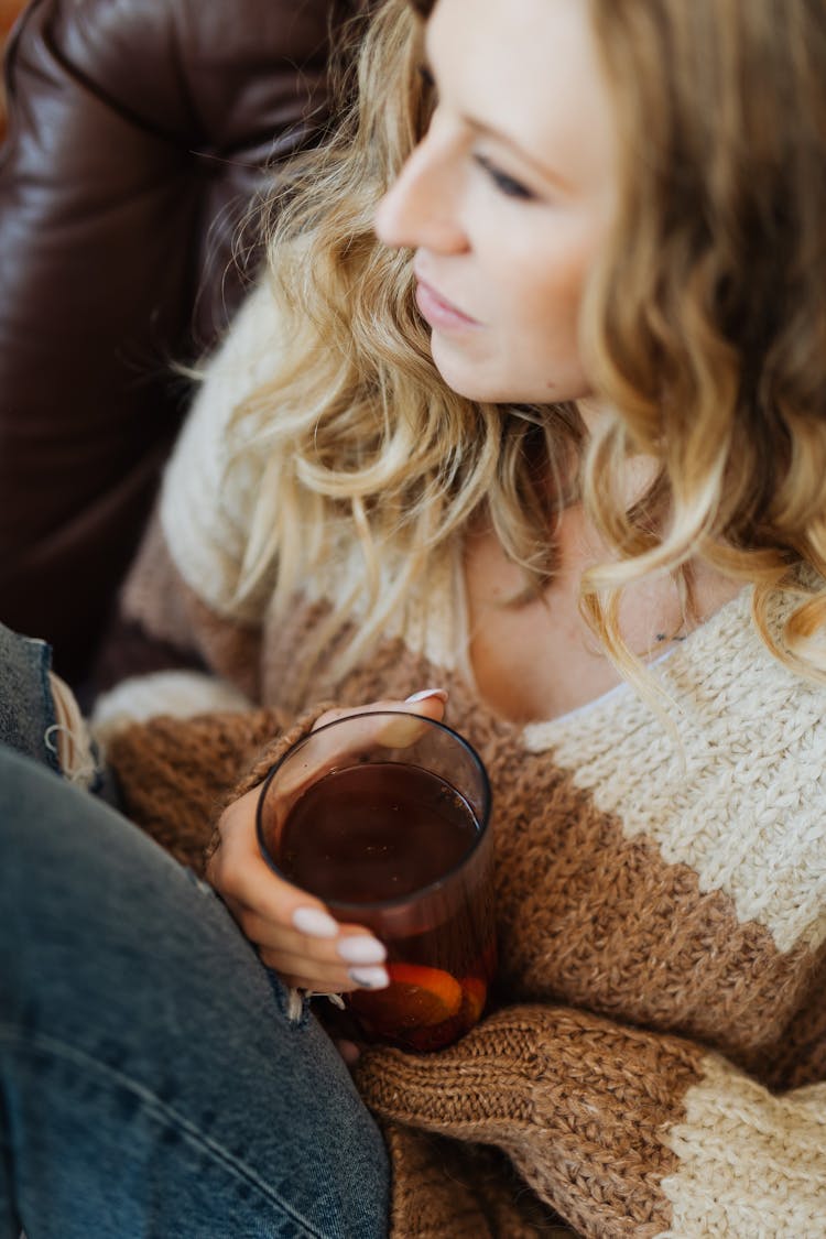 Woman Sitting And Holding A Glass Of Juice 