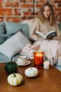 Woman in White Long Sleeve Shirt Sitting on Couch