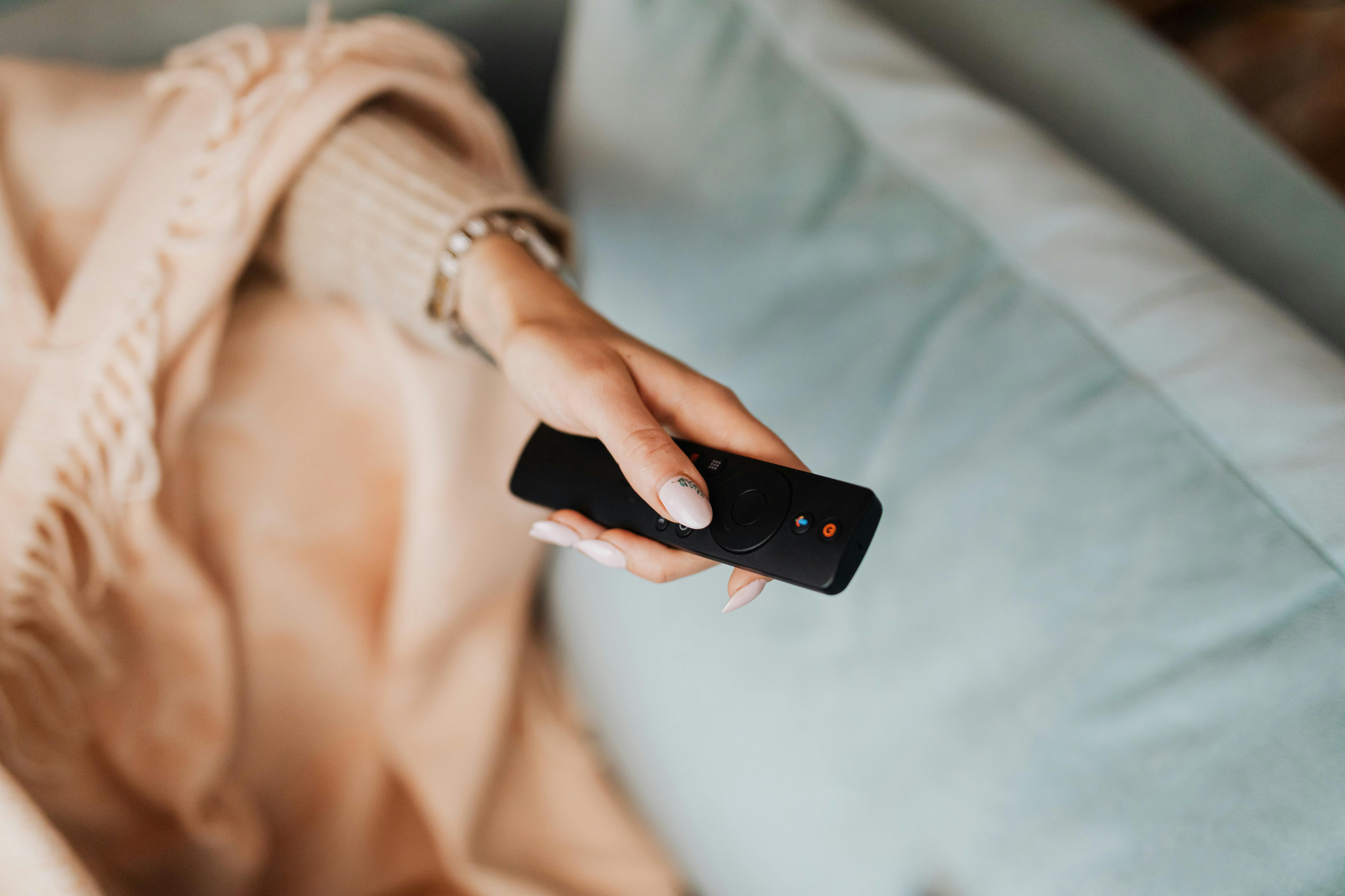 Person Holding Black Remote Control