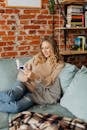 Blonde Woman Sitting on Comfy Sofa and Reading