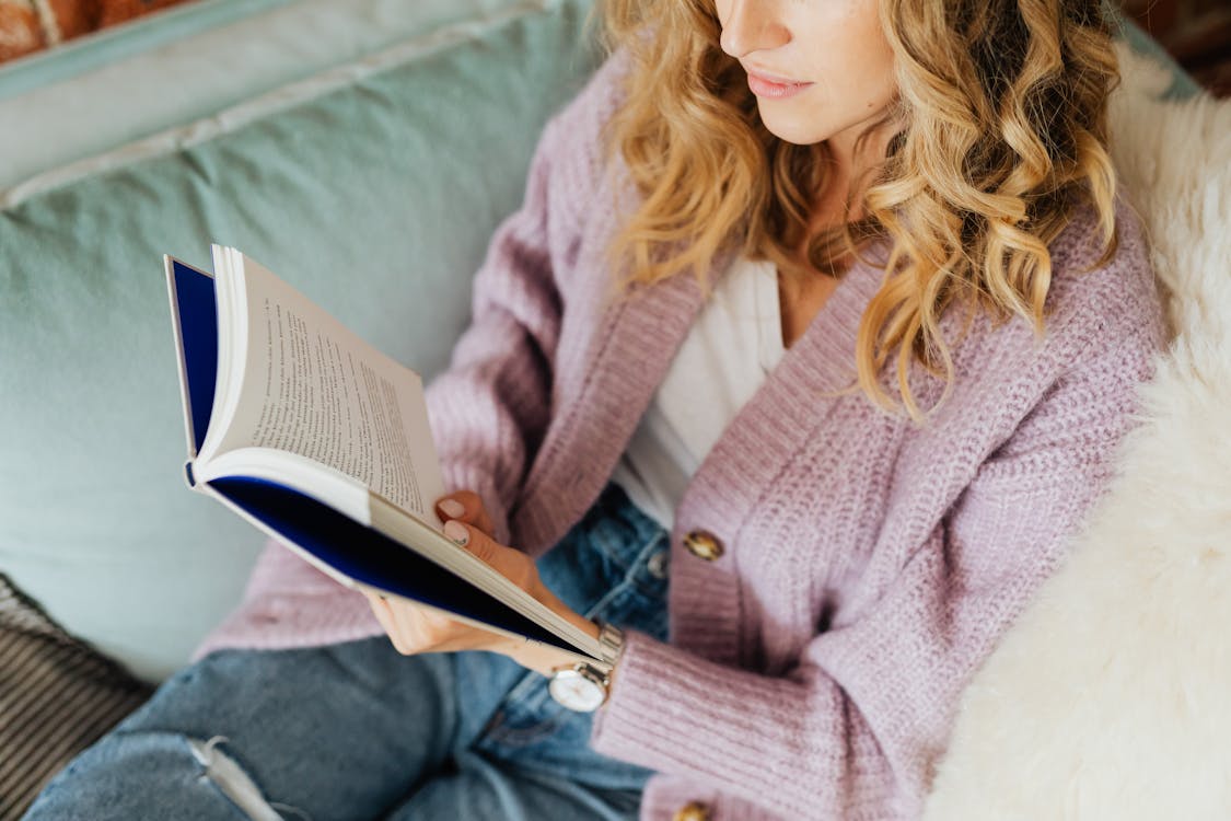 Free Woman in Pink Sweater Reading Book Stock Photo