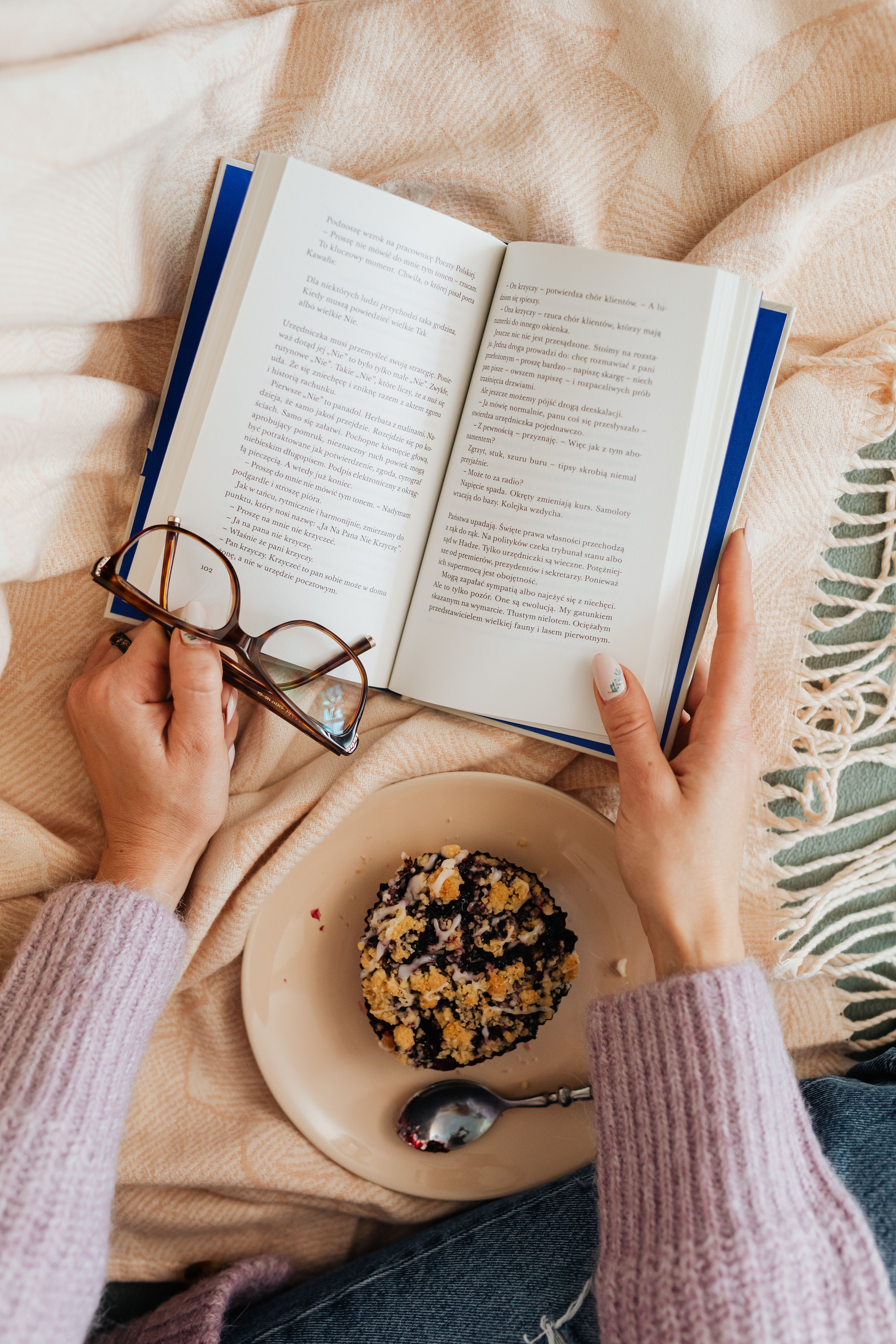 Close-Up Shot of Person Holding a Book and Eyeglasses · Free Stock Photo