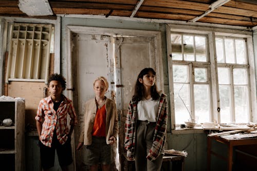 Free Teens Standing Inside the Abandoned Building Stock Photo