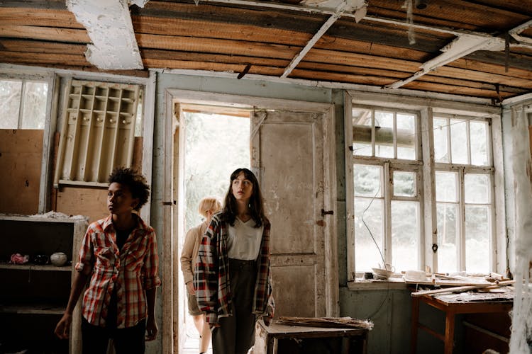 Teens Standing Inside The Abandoned Building
