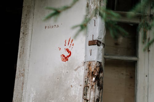 Free Blood Stained Hand on Wooden Door Stock Photo