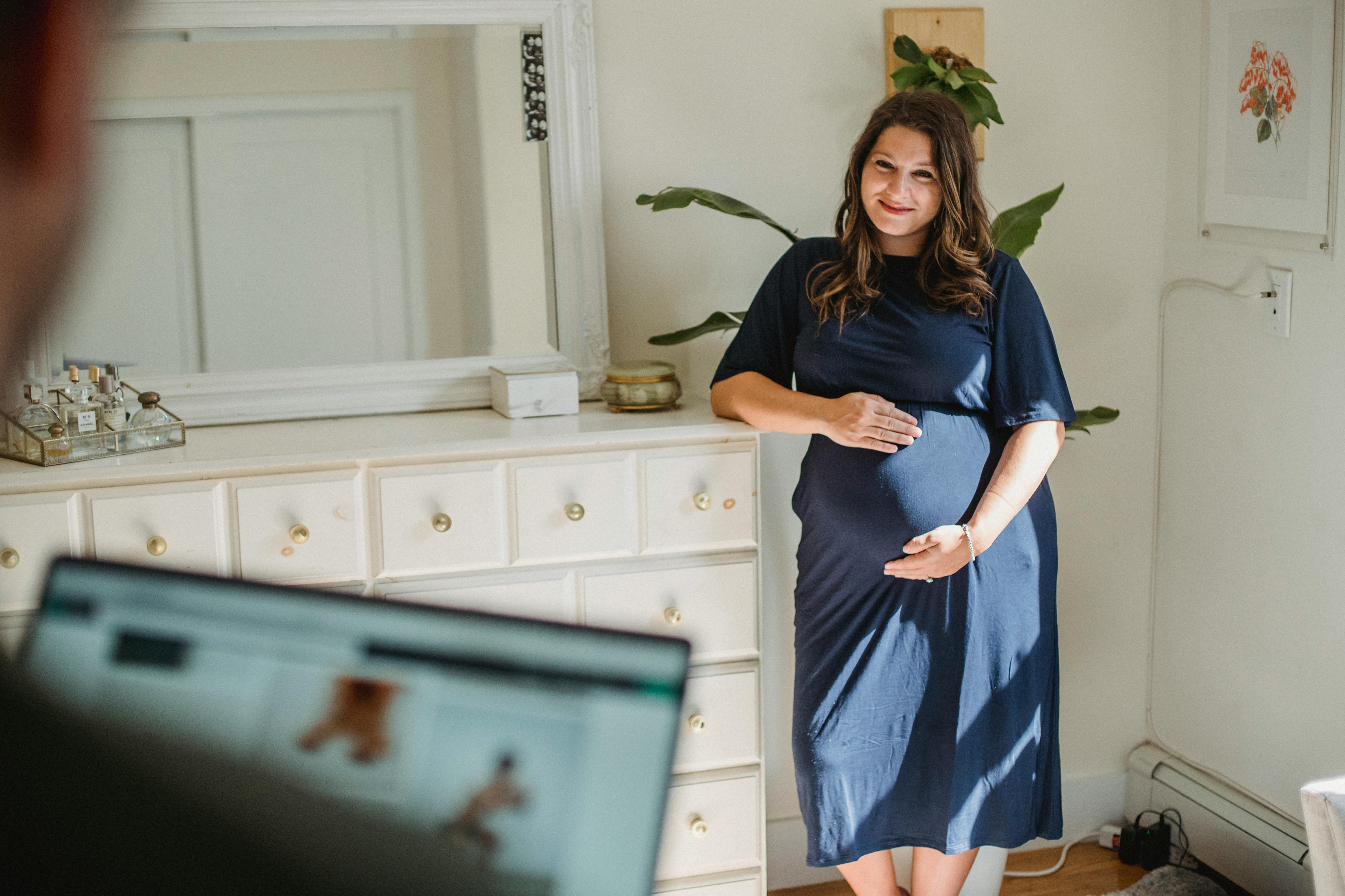 crop man and smiling expectant woman in house room