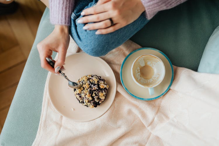 Close-Up Shot Of Person Eating A Delicious Cookie