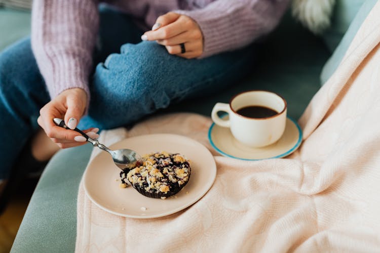 Close-Up Shot Of Person Eating A Delicious Cookie