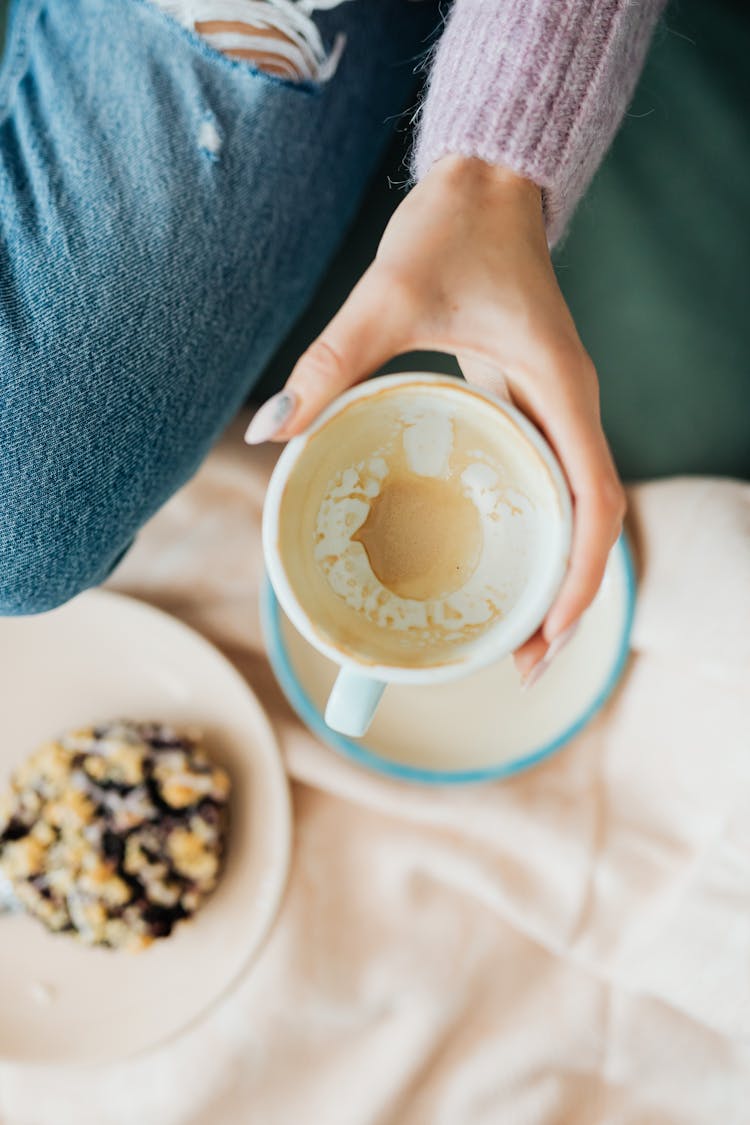 Person Holding An Empty Cup