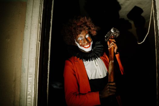 Scary Clown holding a Hammer 