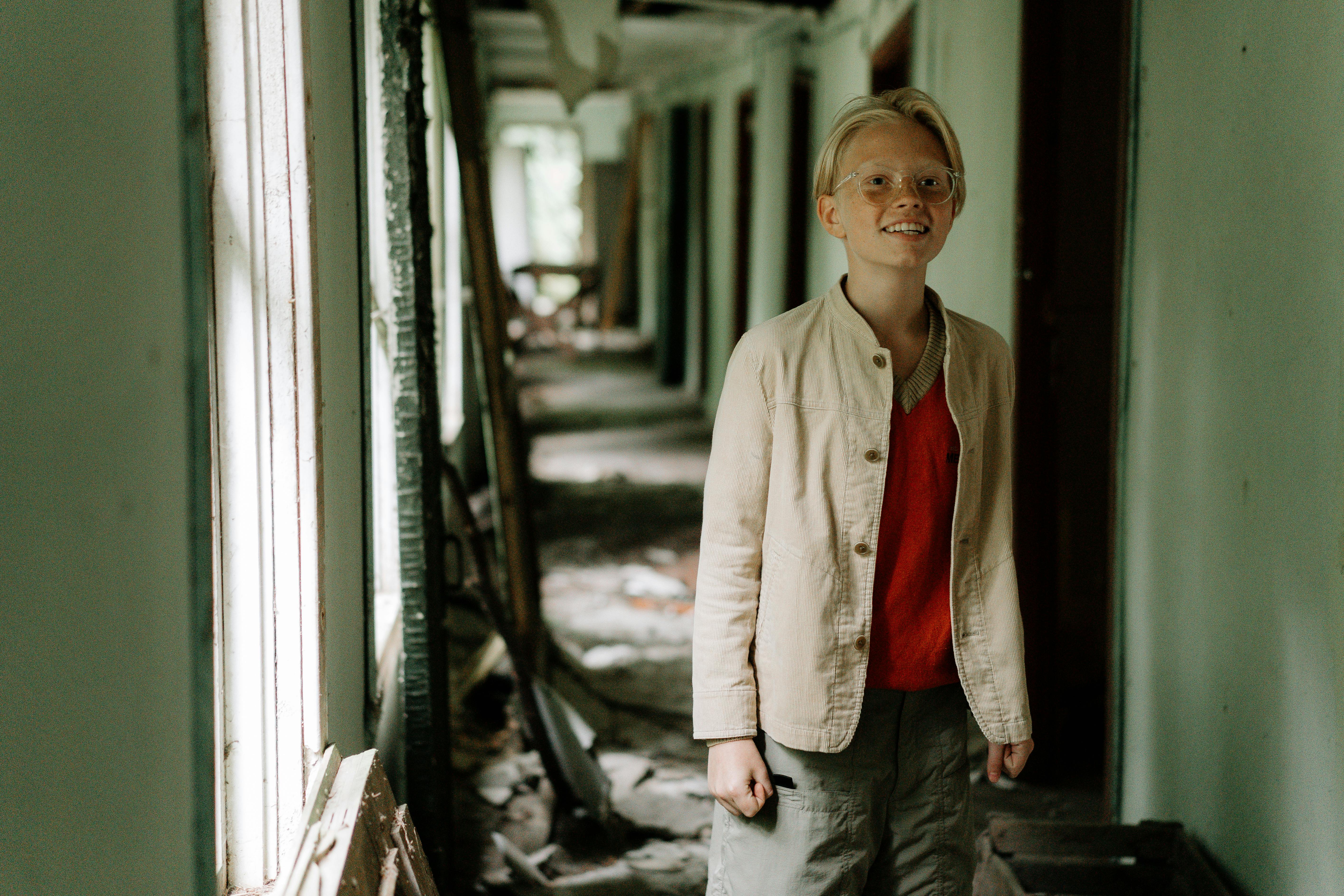 teen in an abandoned hallway