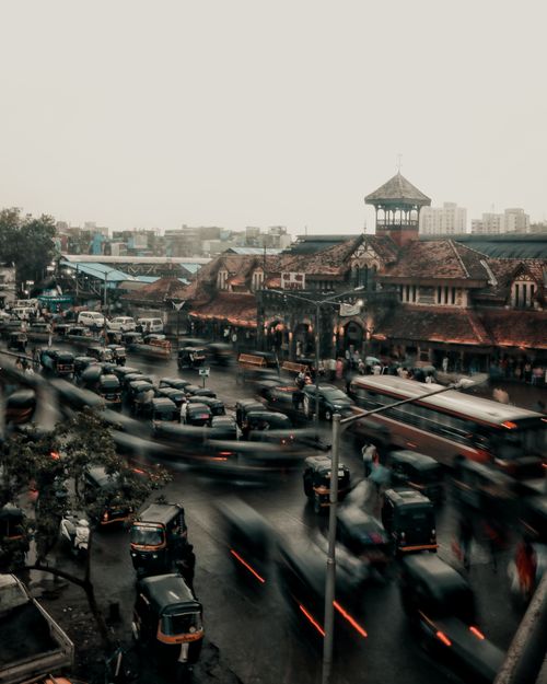 Free Aerial view of a bustling city intersection with heavy traffic and historic buildings in the background. Stock Photo