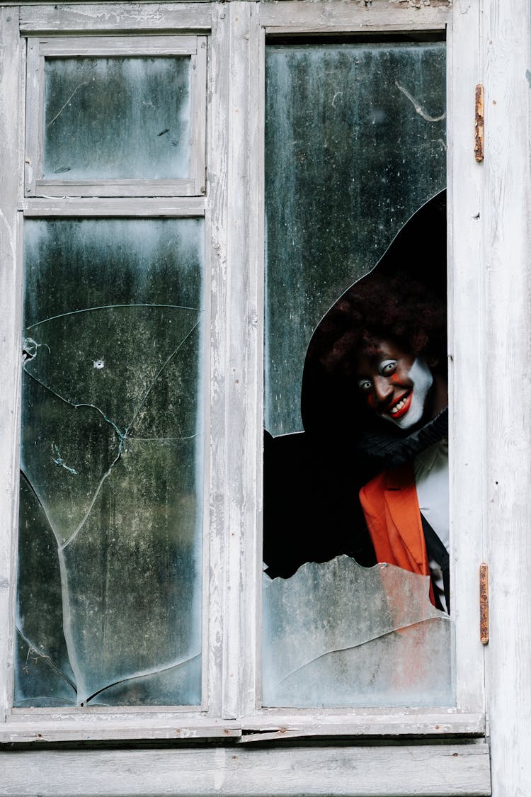 Sinister Clown On A Shattered Window