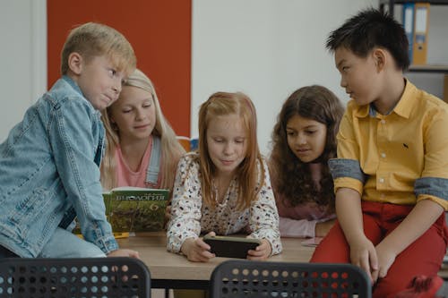 Girl Using a Smartphone inside a Classroom