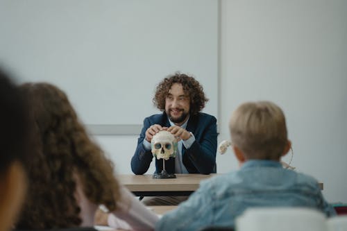 Free Teacher Showing His Class a Human Skull Stock Photo