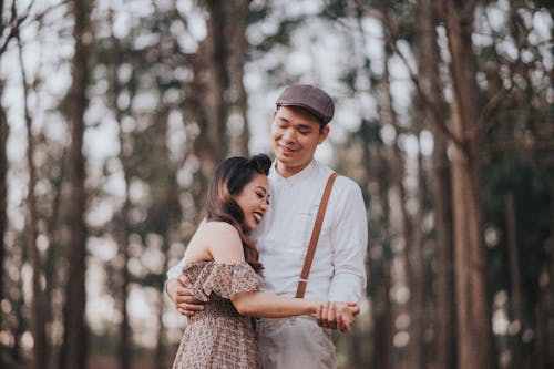 Happy Couple Hugging in a Forest 