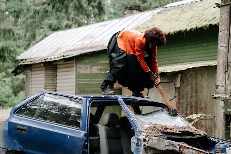 Evil Clown Smashing A Car Windshield With A Sledge Hammer