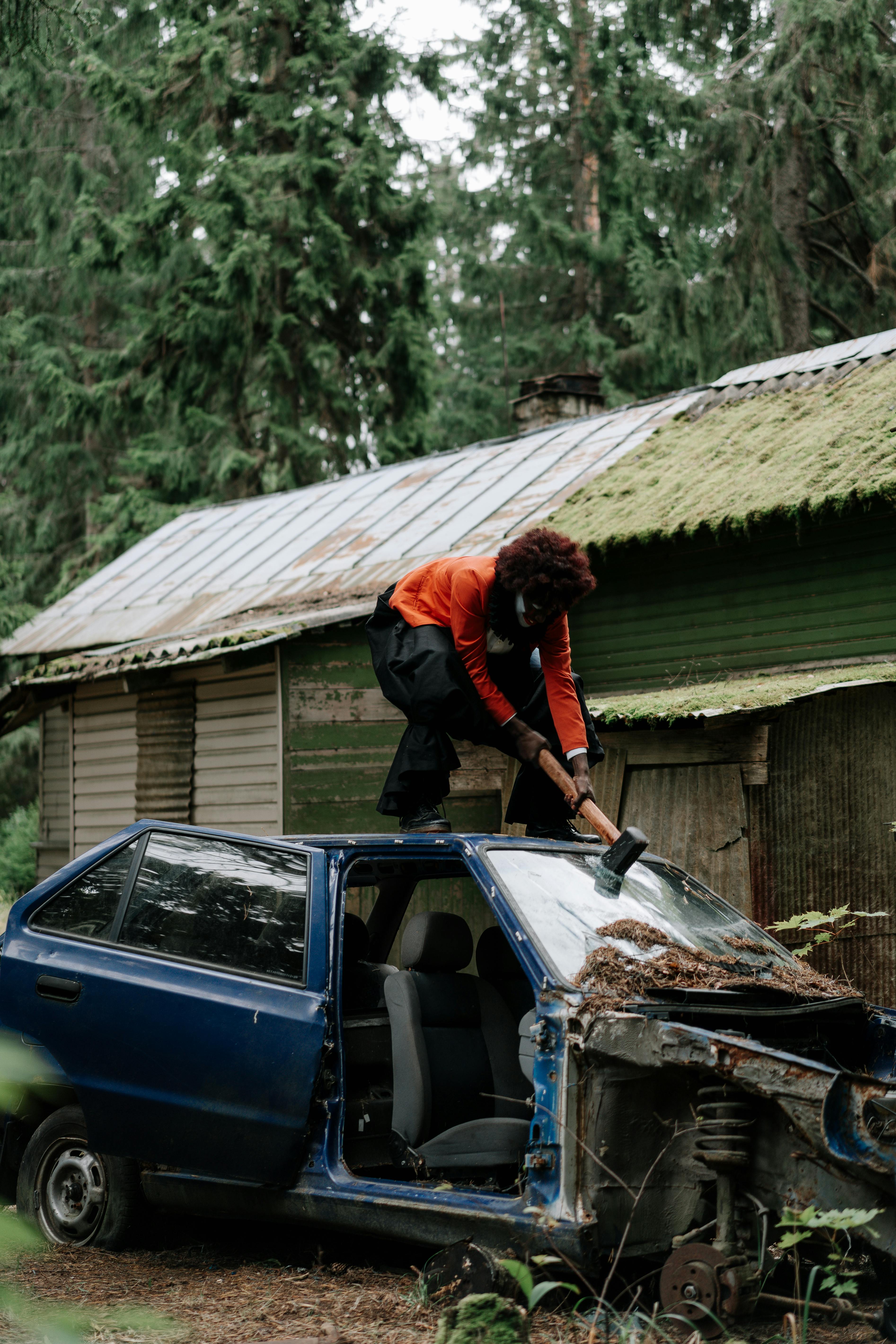 spooky clown smashing a car windshield