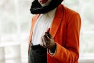 Woman in Black Hijab and Orange Long Sleeve Shirt