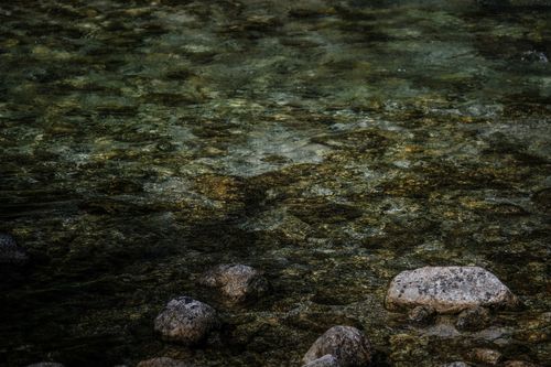 Free From above picturesque view of rippled surface of shallow river with stony bottom at daytime Stock Photo