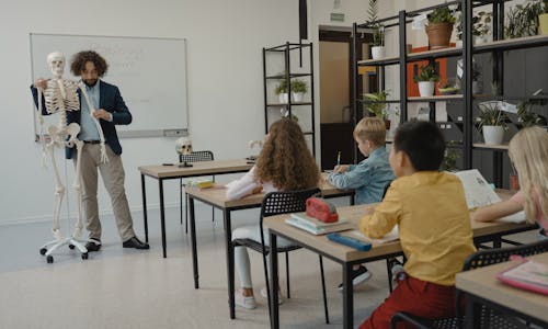 Teacher Discussing in front of His Class