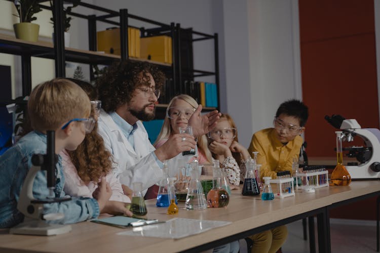 A Teacher Doing Science Experiments With His Students