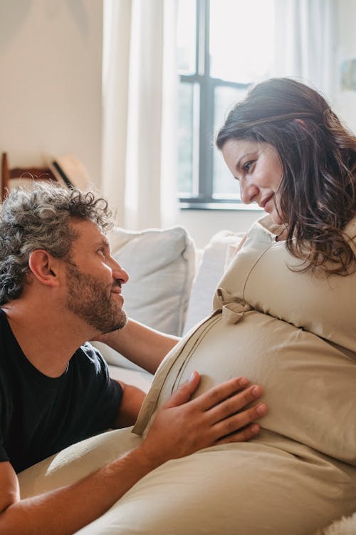 Loving pregnant couple embracing and looking at each other