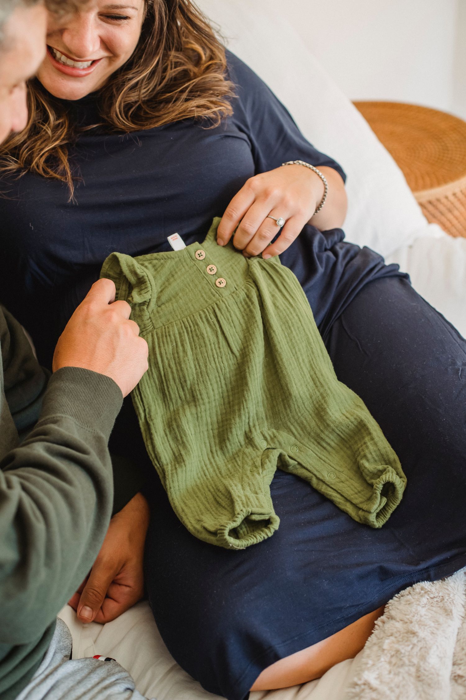 Couple attendant un bébé et choisissant ensemble ses premiers vêtements