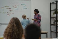 Woman in Pink and White Floral Shirt Standing Beside Woman in Blue Shirt