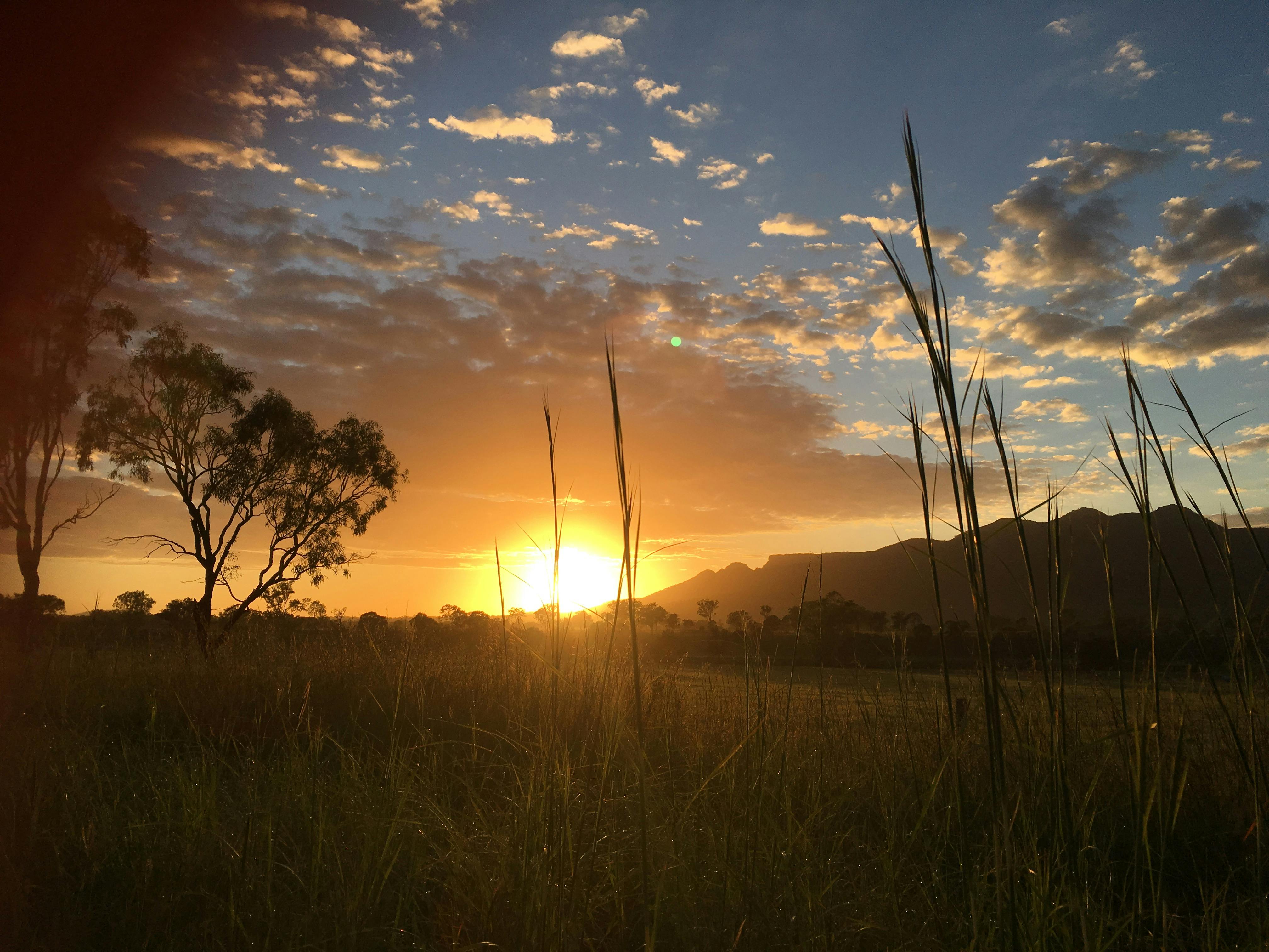 Stunning sunset view over rural fields and mountains in Biggenden, Queensland, Australia.