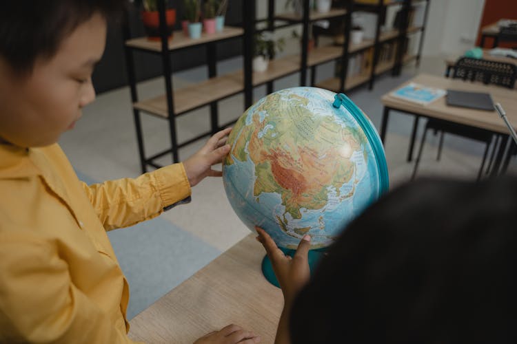 Students Looking At Globe Model 