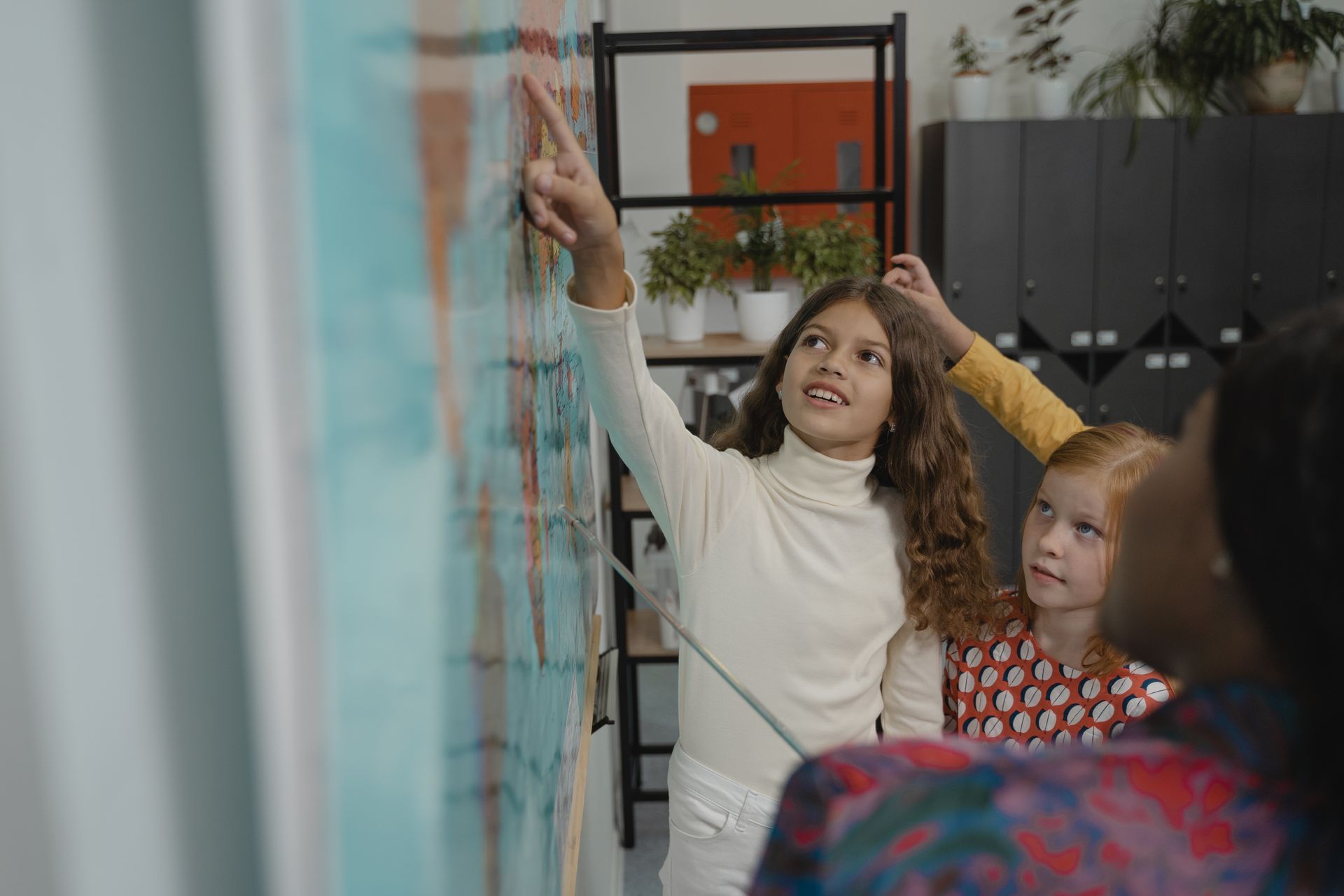 Attentive Student pointing on a Map