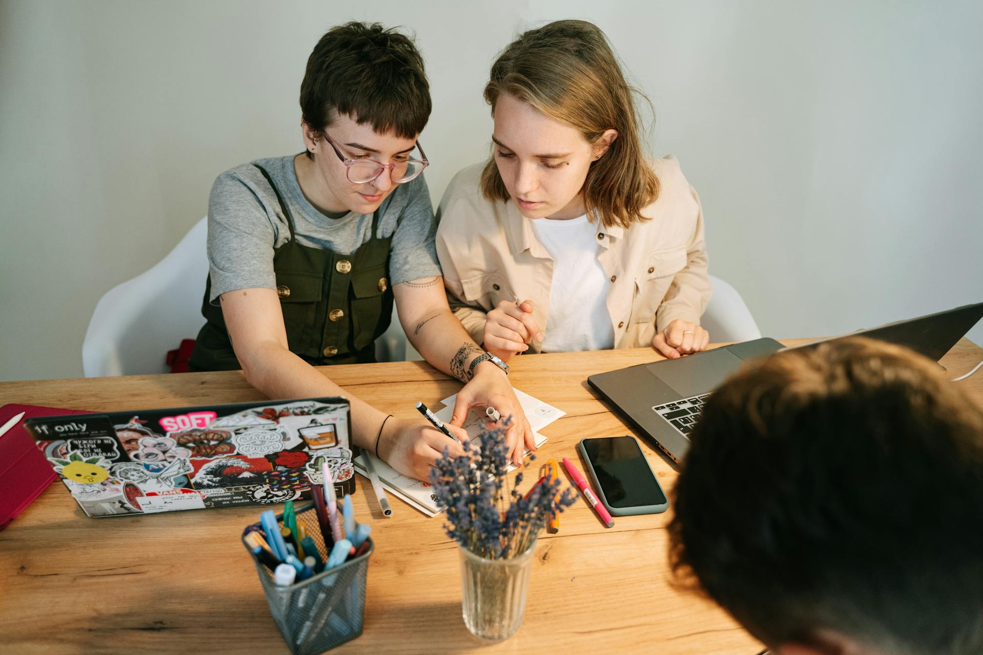 Engaged young professionals brainstorming and collaborating on a project at a modern workspace.