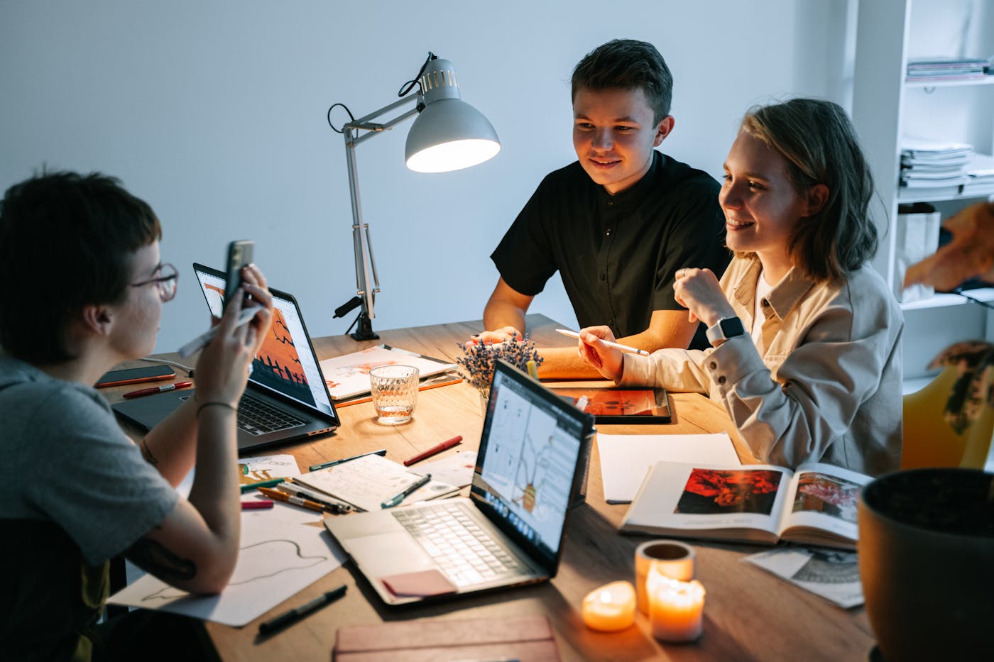 Young professionals collaborating on a laptop in a modern, casual workspace.