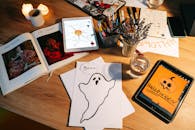 以格林为主题的舒适艺术和手工艺布置中，木桌上摆放着平板电脑和怪异的图画