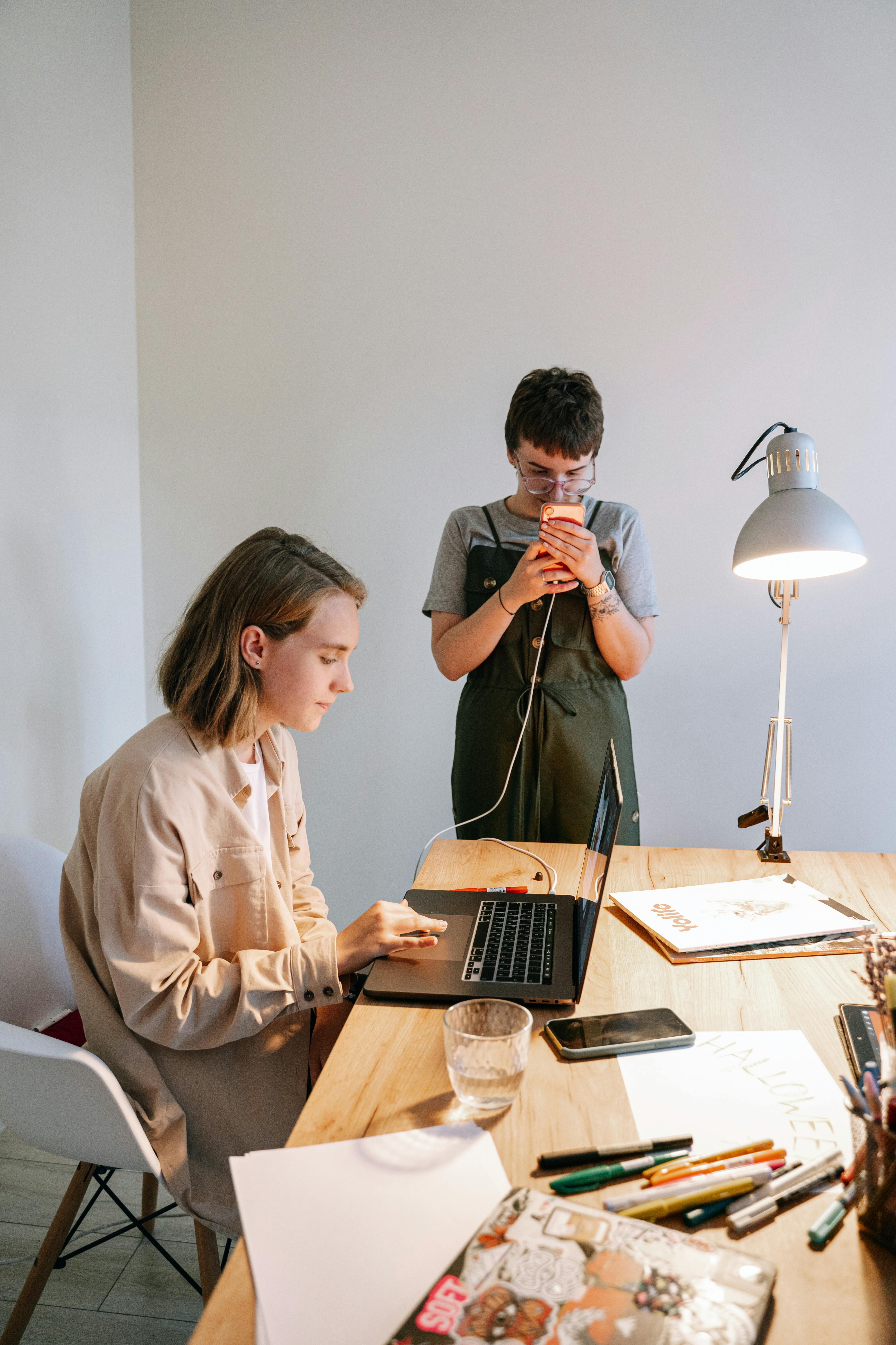 woman in white dress shirt holding black tablet computer