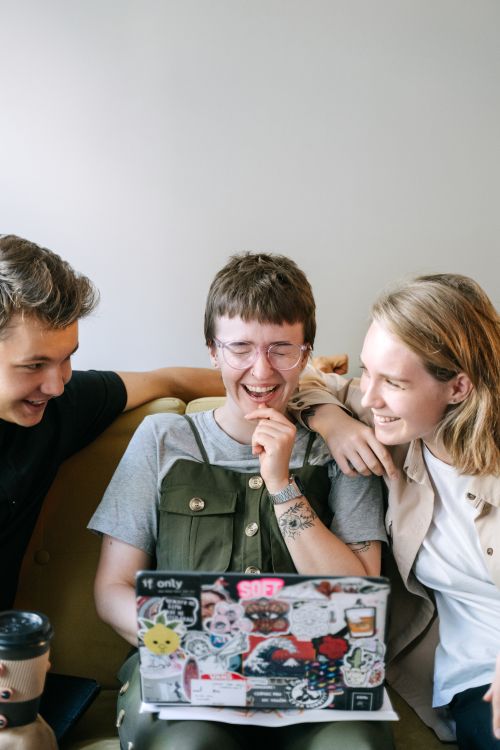 Free Group of young adults enjoying teamwork and collaboration in a modern office setting. Stock Photo