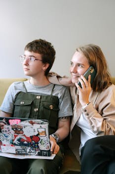Two young professionals engaging with technology in a creative workspace.