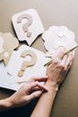 Hands on Top of Paper Crafts