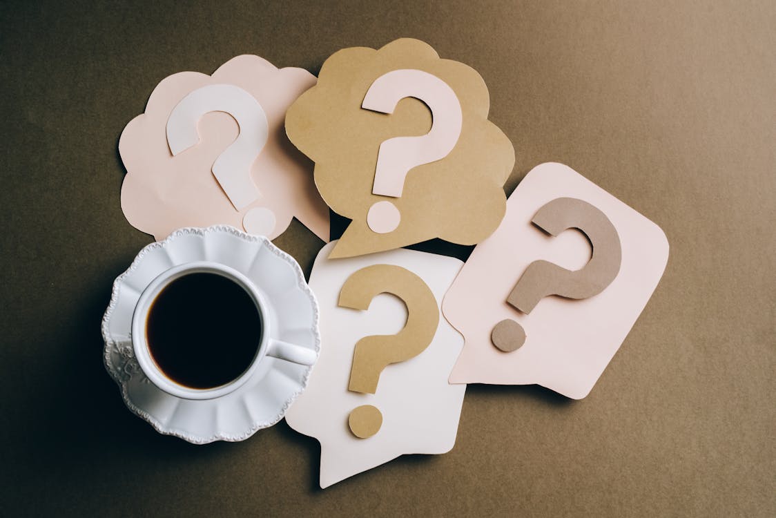 Free Question Marks on Paper Crafts beside Coffee Drink Stock Photo