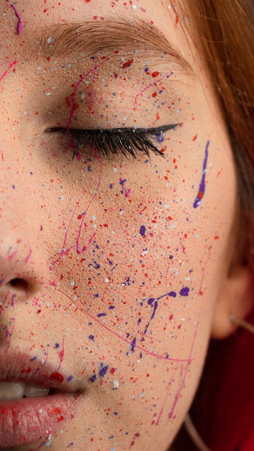 Person With Red and Purple Paint on Face